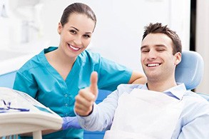Thumbs up man in dental chair