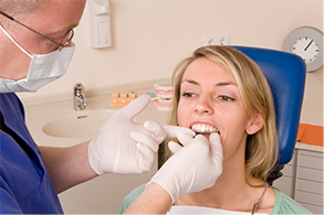 Dentist placing Invisalign tray