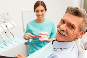 Smiling senior man in dental chair