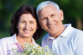 Smiling older man and woman outdoors