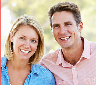 Smiling couple with blonde woman and man in pink shirt