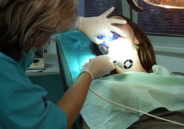 Woman receiving oral cancer screening