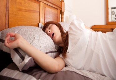 Woman snoring in bed