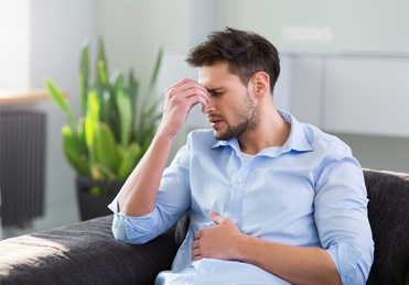 Tired frustrated man with head in hands