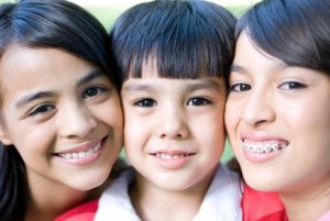 Kids smiling after visiting family dentist